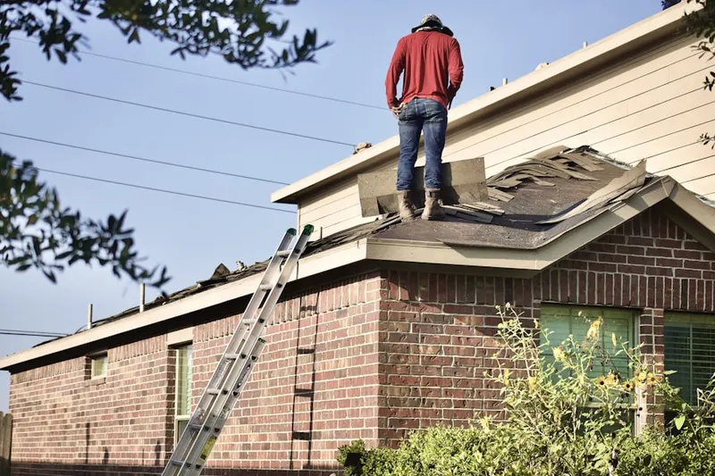 Professional roofer working on a residential roof in Cove Neck